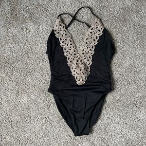 Black one piece swimsuit. Brand is Blue life. Size medium. Worn one time.